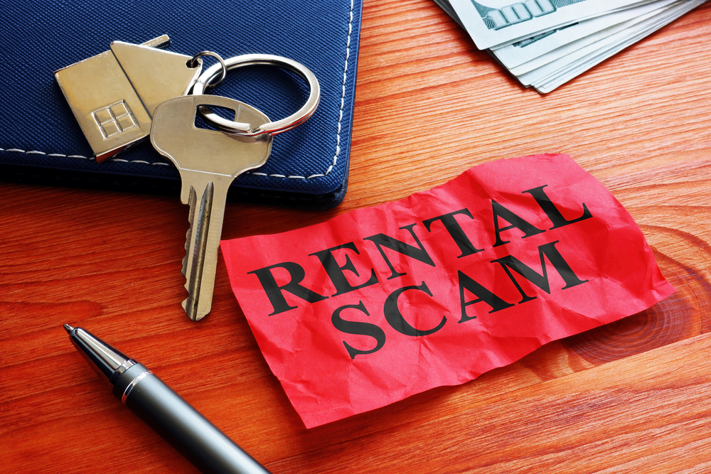 a-pen-and-a-key-with-a-rental-scam-note